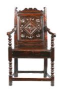 A Charles II oak panel-back open armchair, South Yorkshire, circa 1670 The uprights with inward