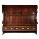 An impressive George III mahogany bowed canopy settle, circa 1770 Having a tall back of ten