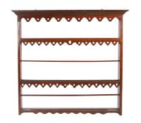 A George III oak Delft rack, circa 1780 Having a dentil-moulded cornice, and pierced wavy-shaped