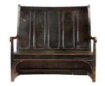 A George III stained pine bowed high-back settle, West Country, circa 1800 The back of five