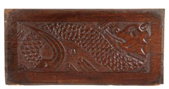 A Charles I oak dragon-carved panel, West Country, circa 1640 Designed with a scrolling scaled body,