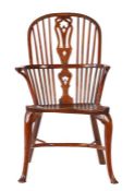 A George II/III Gothic-influenced yew and elm Windsor armchair, circa 1740-80 The hooped back with