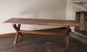 An early 19th century pine trestle table, English, circa 1800-40 Having a twin-boarded round