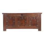 A mid-17th century oak coffer, English, circa 1640-60 Having a plank top, the front of three panels,