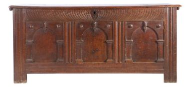 A mid-17th century oak coffer, English, circa 1640-60 Having a plank top, the front of three panels,
