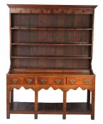 A George III oak high dresser, South Wales, circa 1770 The boarded rack with cavetto-moulded
