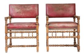 A pair of walnut and 'hide' upholstered 17th century Flemish style open armchairs Each with