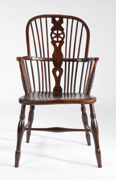 A 19th century ash and elm high-back Windsor armchair, English, circa 1830 The hooped back with