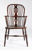 A 19th century ash and elm high-back Windsor armchair, English, circa 1830 The hooped back with