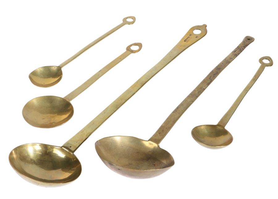 An 18th century brass maker stamped ladle, English Cast with a deep circular bowl, flat tapering