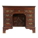 An oak knee-hole desk, English The top formed mainly from one large board, with ovolo-moulded