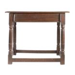 A Charles II oak side table, circa 1680 Having an end-cleated twin-boarded top, a run-moulded drawer