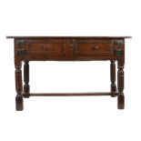 A Charles I oak rent-type table, circa 1630 Having a triple-boarded top, over a pair of panelled