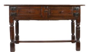 A Charles I oak rent-type table, circa 1630 Having a triple-boarded top, over a pair of panelled