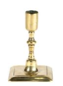 A good dwarf brass candlestick, circa 1700 In the Huguenot manner, having a plain straight-sided