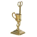 A good George I brass upright candle-snuffer and stand, circa 1720 The snuffer, or wick trimmer,