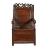A Charles II oak panel-back and box-seated open armchair, Cheshire, circa 1670 Having a plain