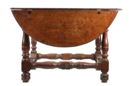 A 17th century oak gateleg table, of unusual design, Flemish Having a large oval drop, formed from a