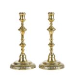 A pair of George II brass candlesticks, circa 1750 Each with an inverted-baluster and knopped linear