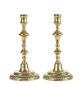 A pair of George II brass candlesticks, circa 1750 Each with an inverted-baluster and knopped linear