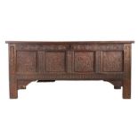 A Charles I joined oak coffer, circa 1640 Having a twin-panelled lid, the front of four panels, each
