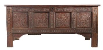 A Charles I joined oak coffer, circa 1640 Having a twin-panelled lid, the front of four panels, each