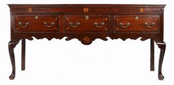 A George III oak and inlaid low dresser, North-West/West Midlands, circa 1780 The top of two wide