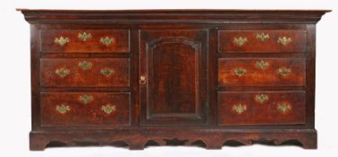 An early George III oak fully enclosed dresser base, circa 1770 Having a twin-boarded top, and
