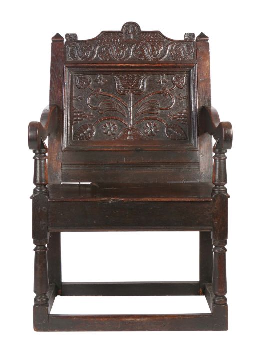 A Charles II oak panel-back open armchair, Lancashire, circa 1670 Having a flattened scroll profiled