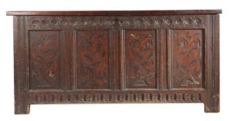 A James I oak and marquetry inlaid coffer, circa 1620 Having a quadruple-panelled lid, the front