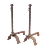 A pair of cast iron andirons Each with faceted-ball finial, and ratchet dog-tooth uprights, on