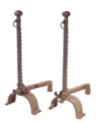 A pair of cast iron andirons Each with faceted-ball finial, and ratchet dog-tooth uprights, on