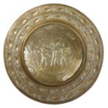 A 19th century brass alms dish or charger The bossed centre engraved with Adam & Eve, within a