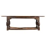 A late 16th century style oak refectory table, circa 1900 Having a one-piece top, nulled-carved