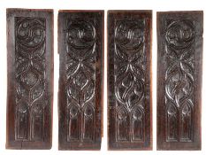 A set of four late 15th century oak panels, circa 1480 Of paired design, each tracery carved, with