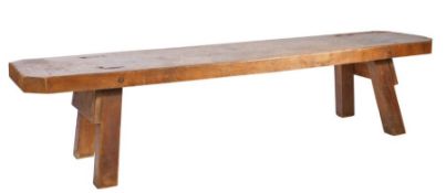 A 19th century elm 'pig' bench Having a wide one-piece, deep, top, on trestle end-supports, 190.