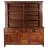 A George III oak high dresser, Yorkshire, circa 1780 The boarded rack with wavy-shaped frieze,