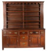 A George III oak high dresser, Yorkshire, circa 1780 The boarded rack with wavy-shaped frieze,