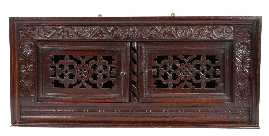 A striking Commonwealth oak mural cupboard, North Country, dated 1651 The top and sides with