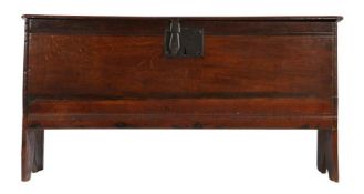 A mid-17th century oak boarded chest, English, circa 1650 The hinged lid with ovolo-moulded front