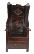 A rare late 17th century joined oak lambing chair, Lancashire, circa 1680-1700 Having a twin-