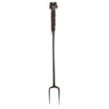 A George I/II iron meat fork, circa 1720-50 With two tines, the stem with twist-work flattening into