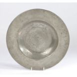 A 17th century pewter broad-rim plate, North European, circa 1650 With gentle booge, the rim