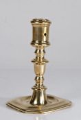 A late 17th century brass candlestick, Flemish The cylindrical socket with small circular extraction