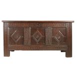 A Charles I oak coffer, North Country, circa 1640 Having a triple-panelled lid with pivotal side