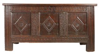 A Charles I oak coffer, North Country, circa 1640 Having a triple-panelled lid with pivotal side
