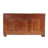 A 17th century oak coffer, German/Flemish The lid with three raised panels, and conforming front,