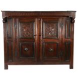 An unusual Charles II oak court cupboard, dated 1681 Having a projecting nulled-carved frieze