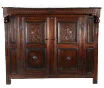 An unusual Charles II oak court cupboard, dated 1681 Having a projecting nulled-carved frieze