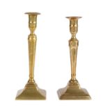 Two similar late 18th century brass candlesticks, English, circa 1780 Each with a tall circular